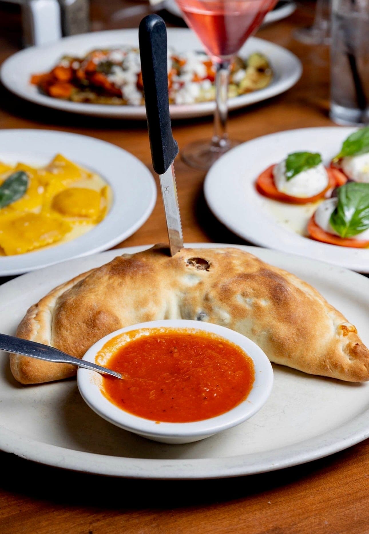 Ricotta and mozzarella calzone with marinara dipping sauce.