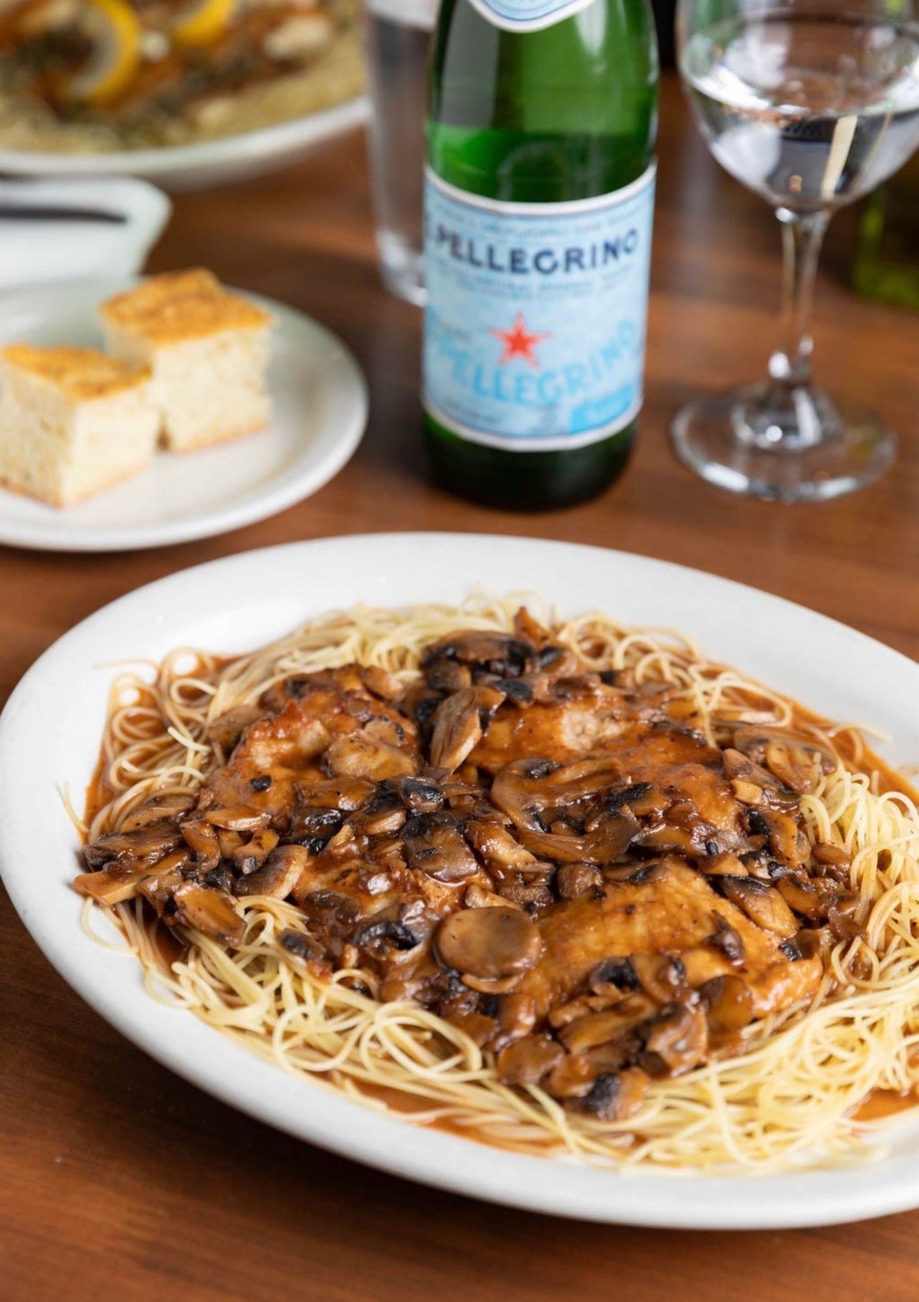 Chicken marsala over angel hair pasta with mushrooms in marsala sauce.