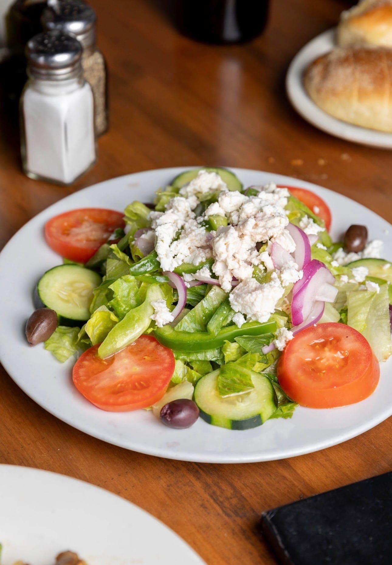 Greek salad with feta, olives, and Greek dressing.