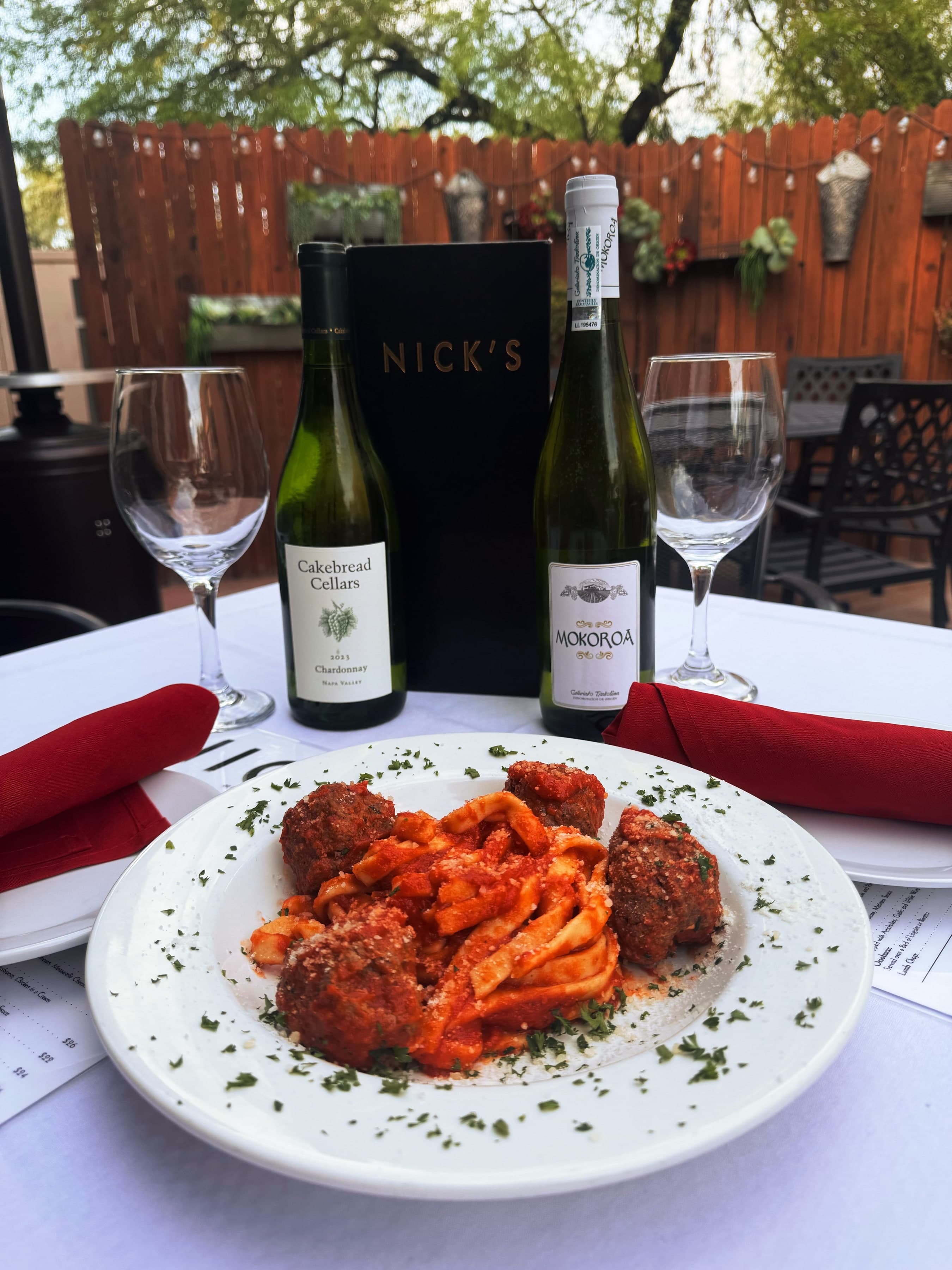Italian restaurant table with wine and dishes at Nick's Italian.