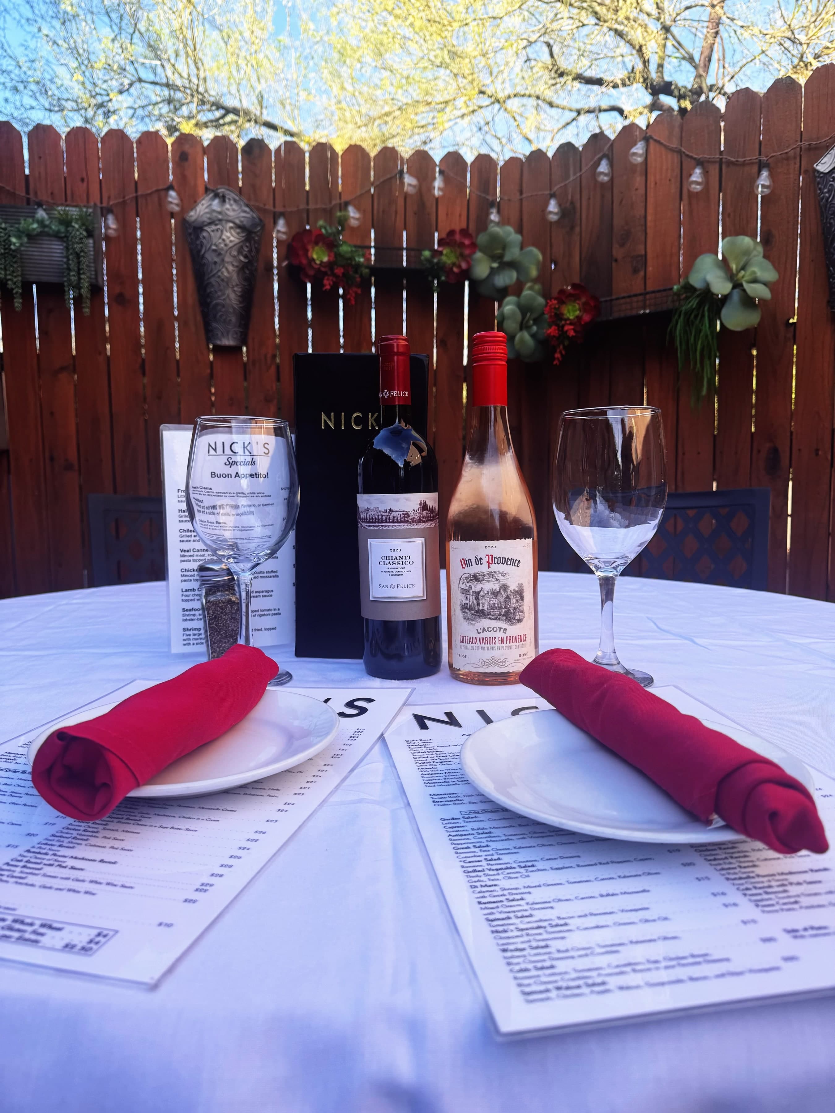 Patio table at Nick's at Frank Lloyd Wright with wine bottles and Nick's menus.