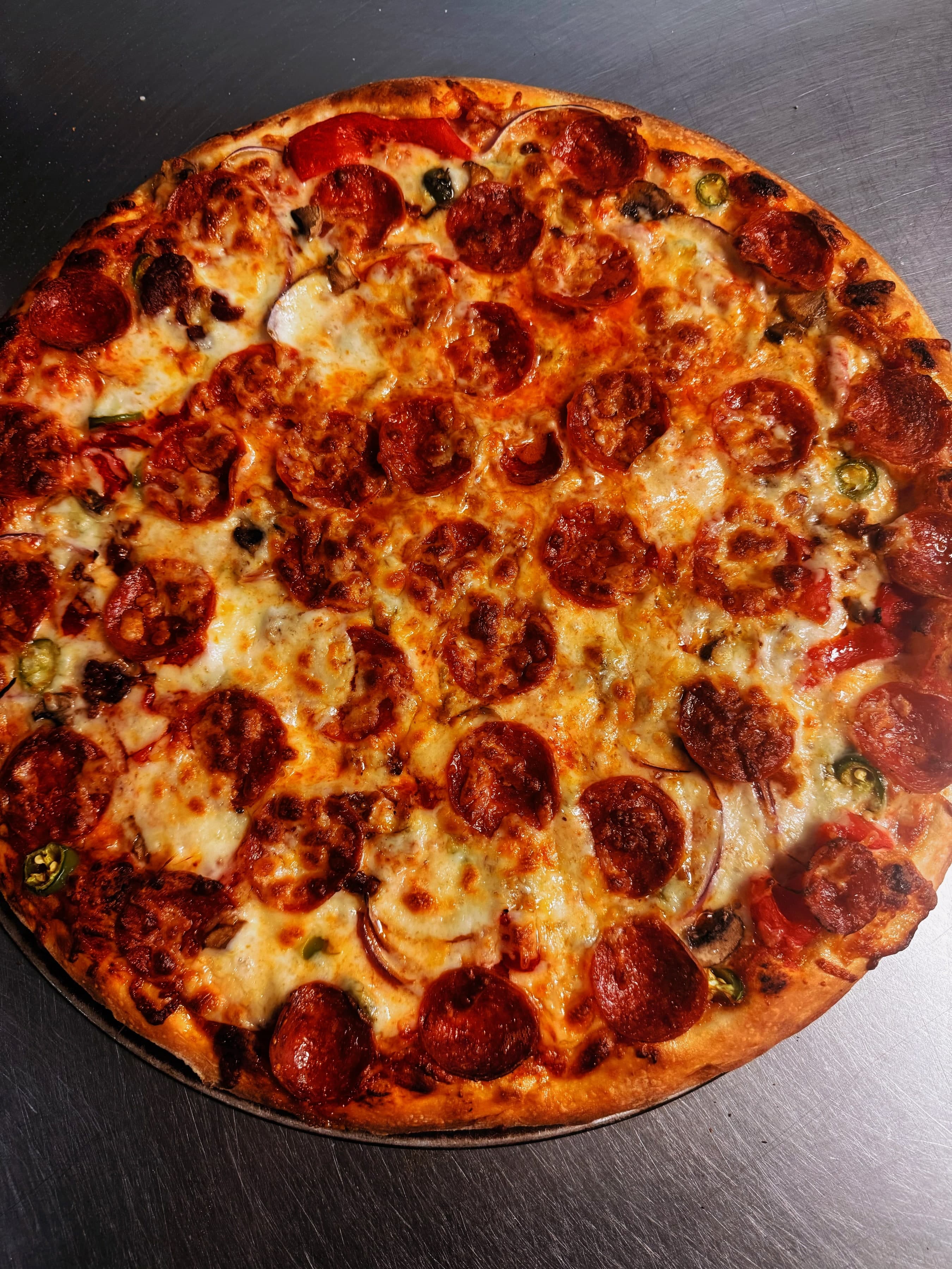 Stone-baked pizza with bubbly mozzarella and golden crust.