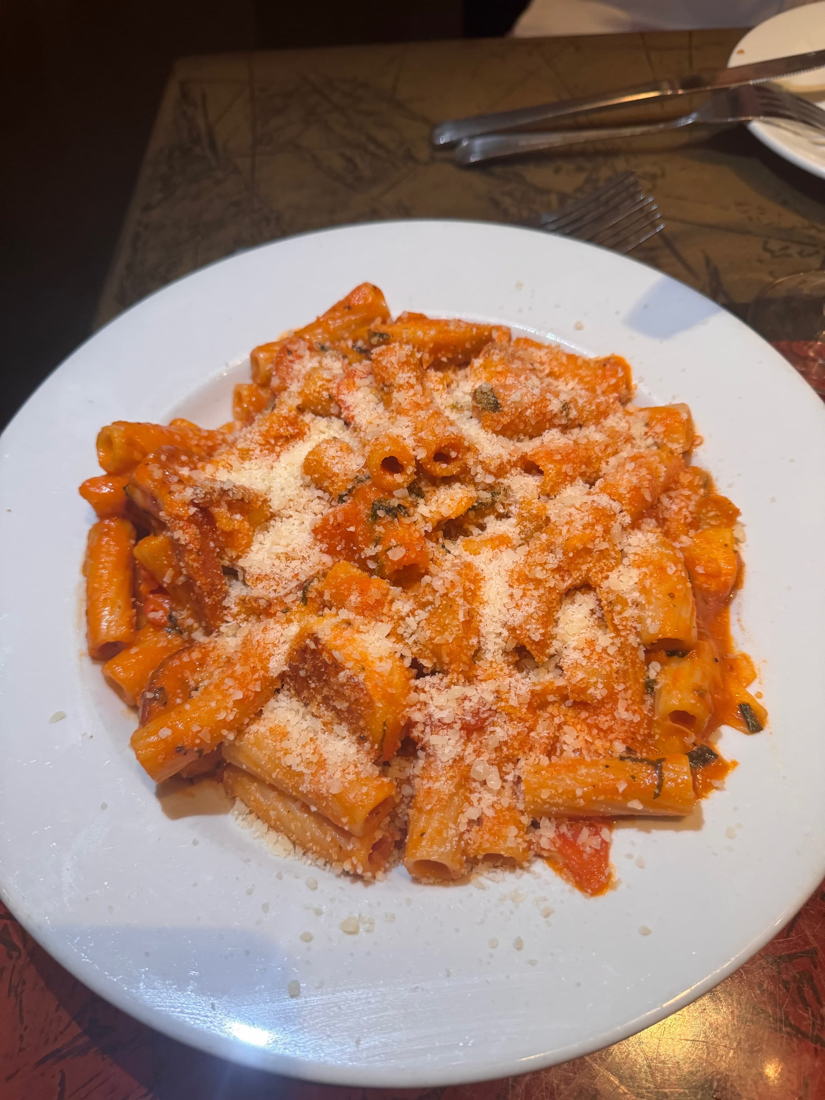 Romantic couple dining at Nick's Pinnacle Peak with wine and Italian dishes.